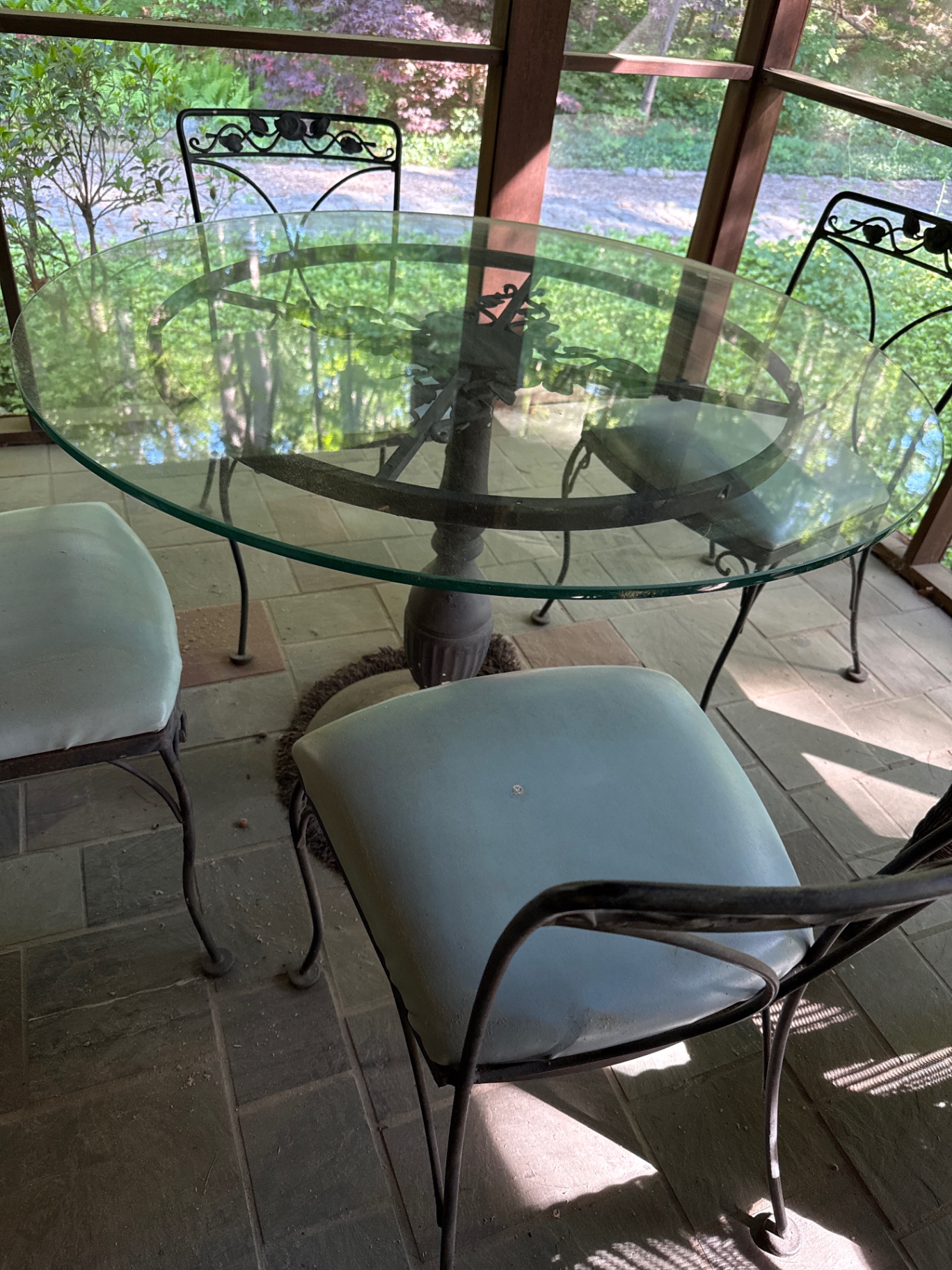 Round glass dining table with four cushioned metal chairs - image 2 of 4
