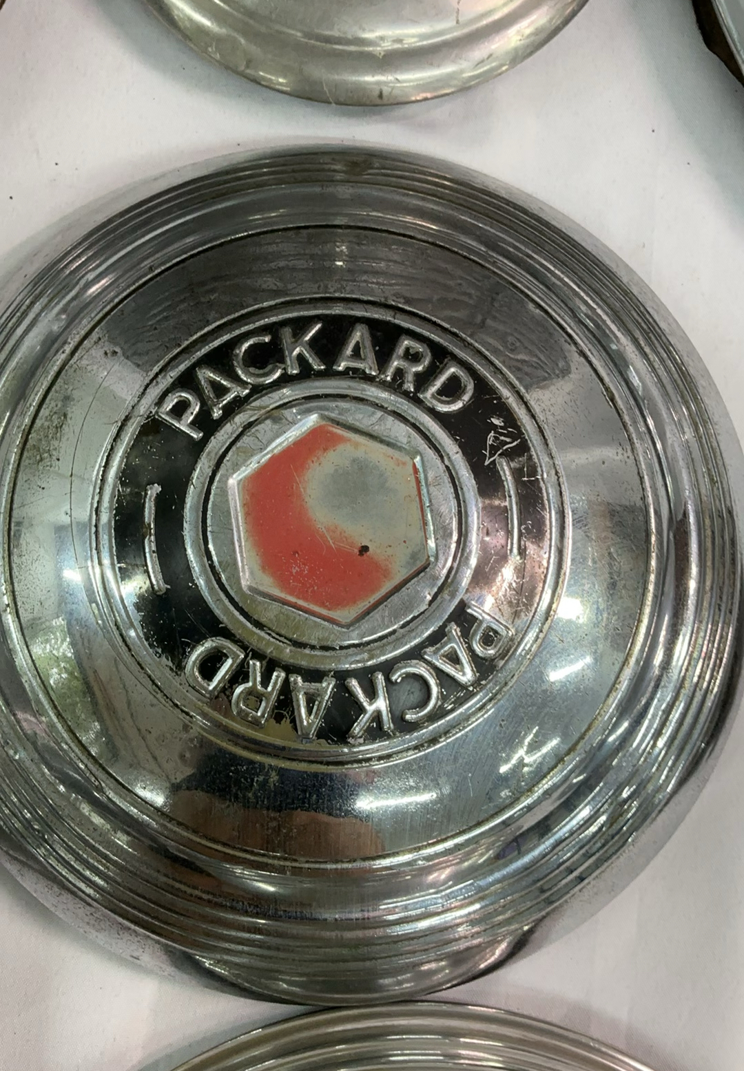 Vintage chrome car hubcaps and grille pieces - image 5 of 8