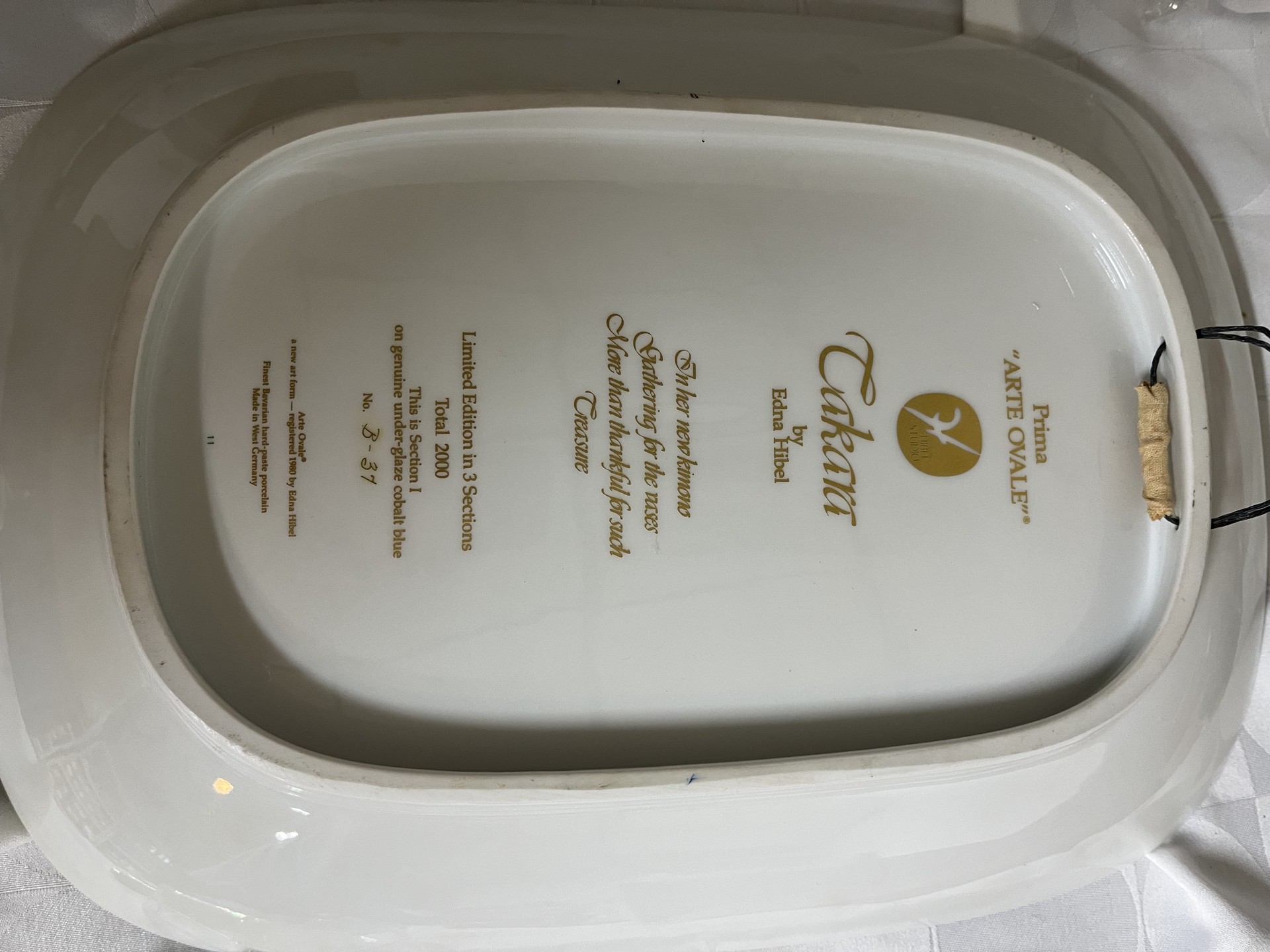Decorative ceramic plate with robed figure and gold botanical motif - image 2 of 3