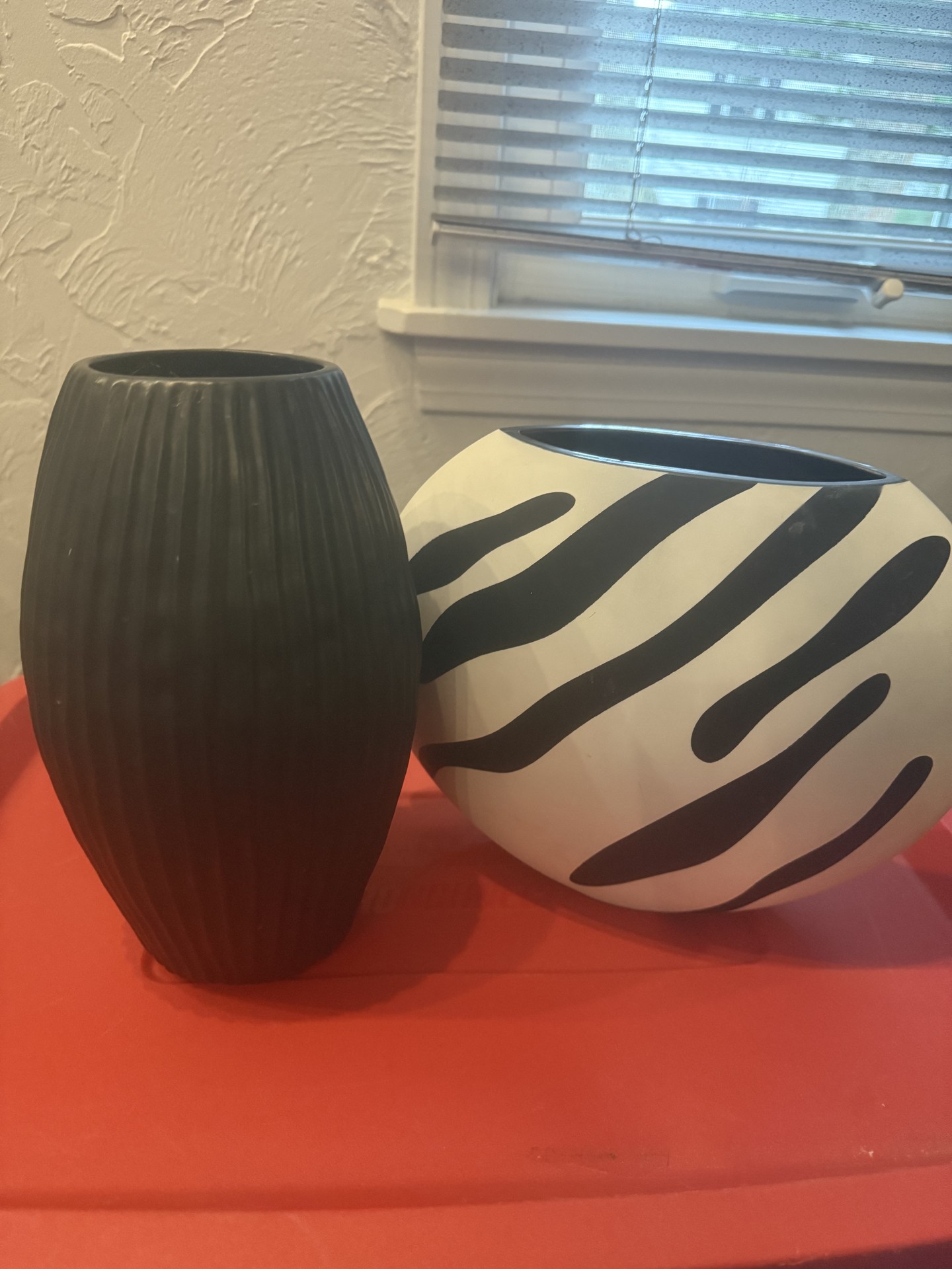 Tall black ribbed vase and white zebra-patterned vase - image 1 of 3