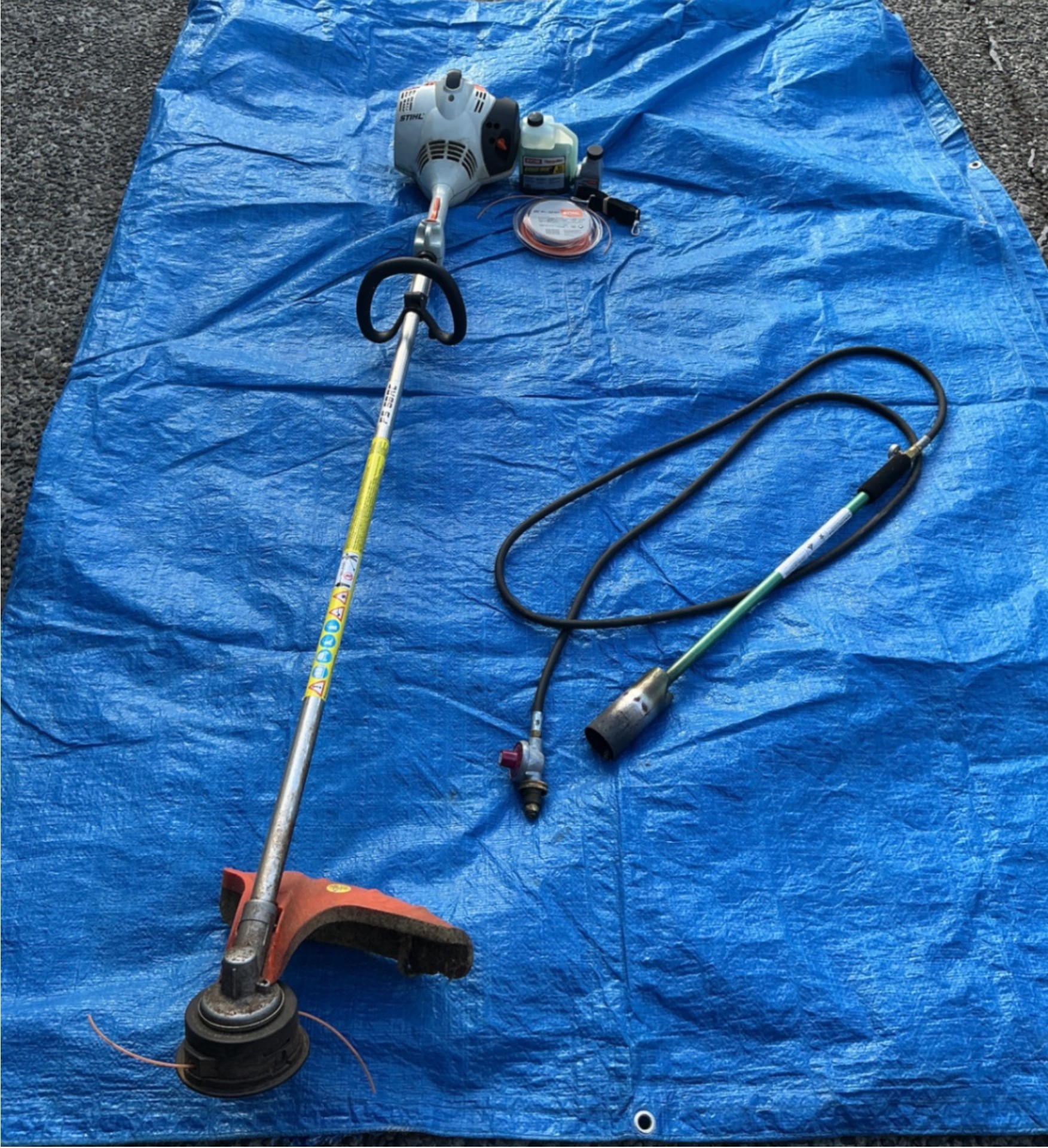 Stihl FS 56 RC string trimmer with fuel, line spool, and weed burner components - image 1 of 6
