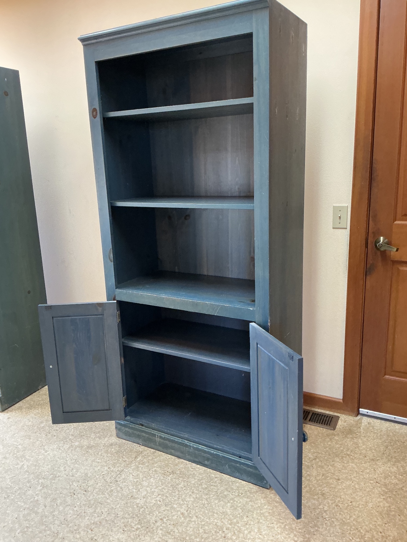 Blue wooden bookcase with open shelving and bottom cabinet. - image 3 of 3