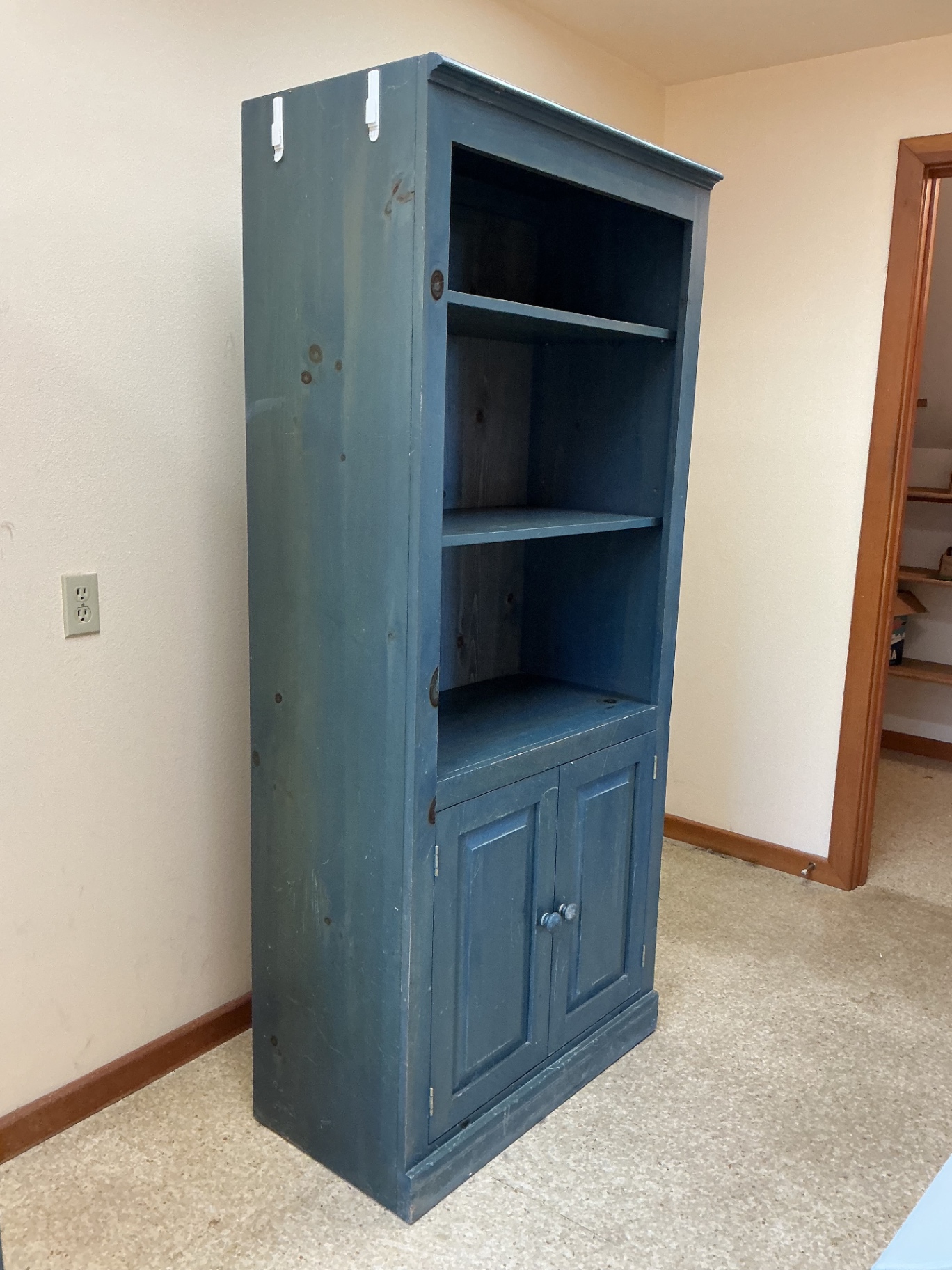 Blue wooden bookcase with open shelving and bottom cabinet. - image 2 of 3