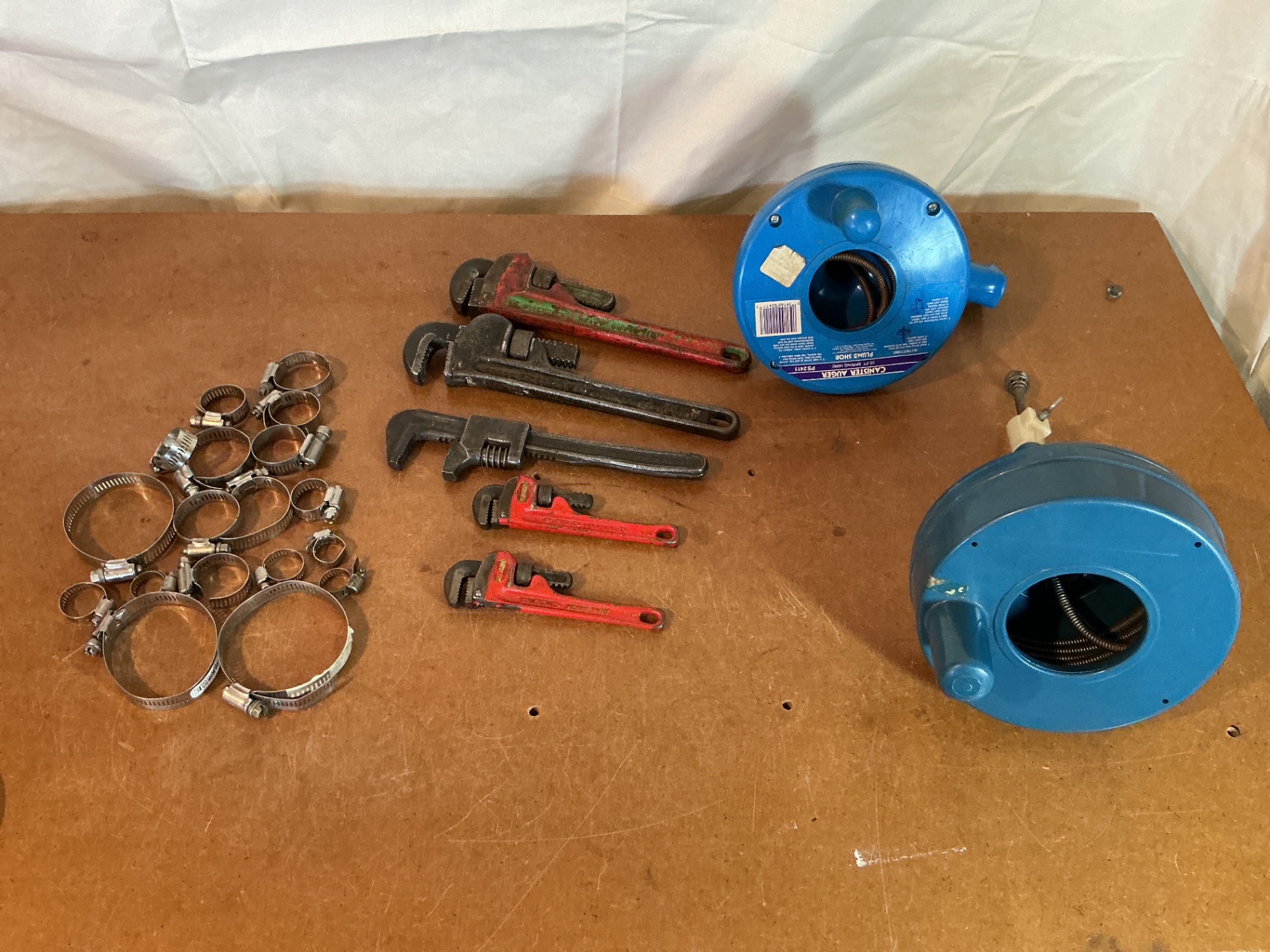 Assorted hose clamps, wrenches, and blue hose reels - image 1 of 3