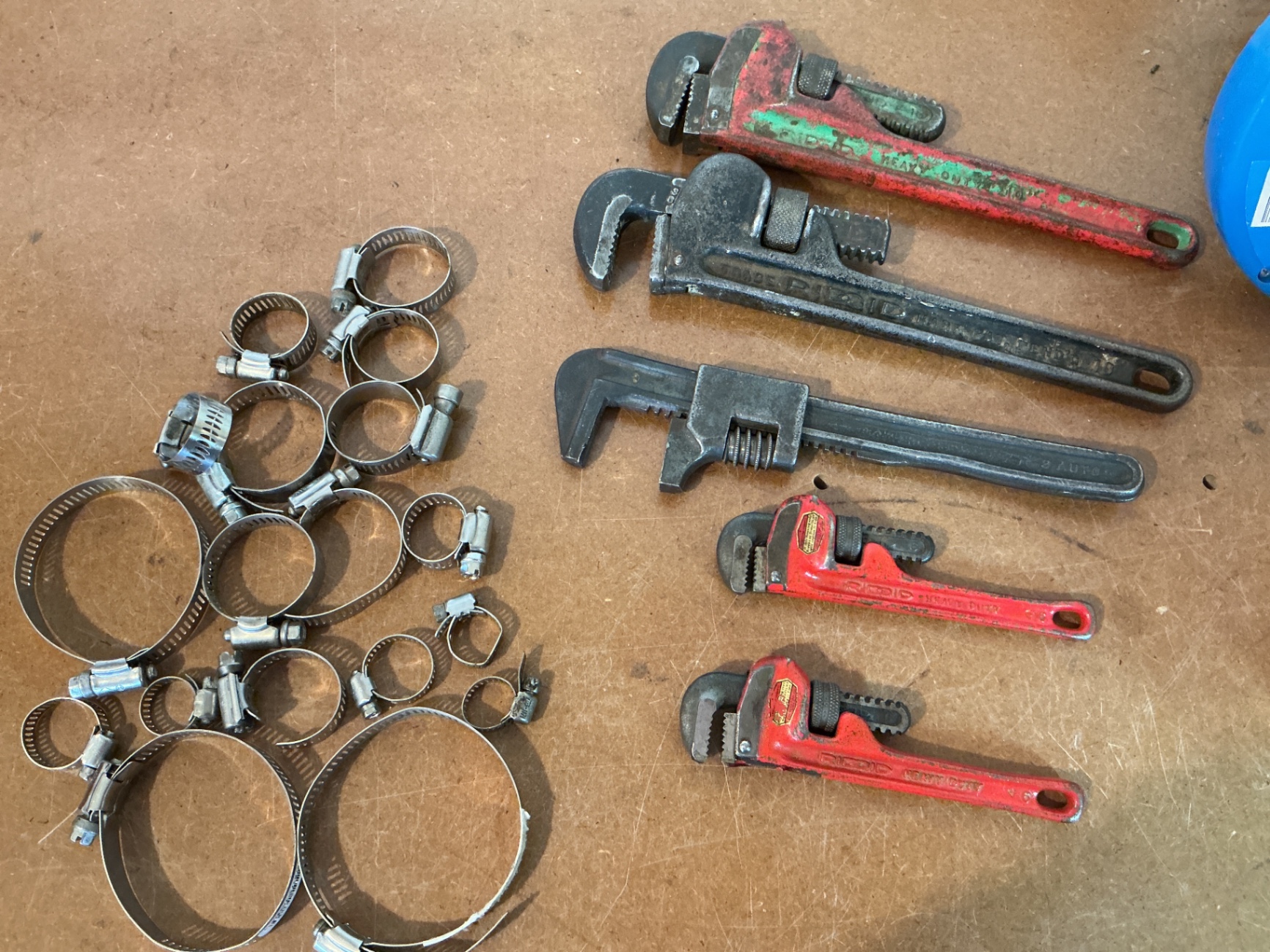 Assorted hose clamps, wrenches, and blue hose reels - image 2 of 3