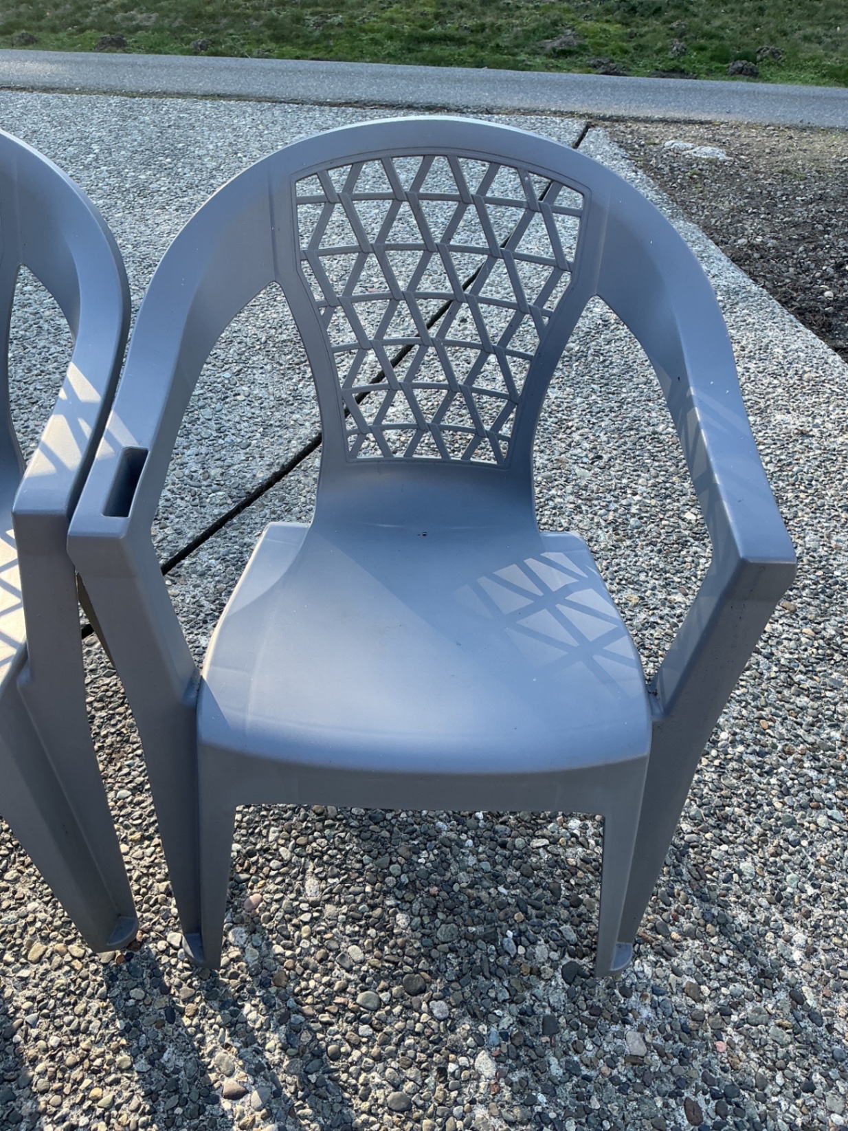 Two gray plastic patio chairs with lattice backs and two round tables (mesh and glass-top) - image 3 of 3