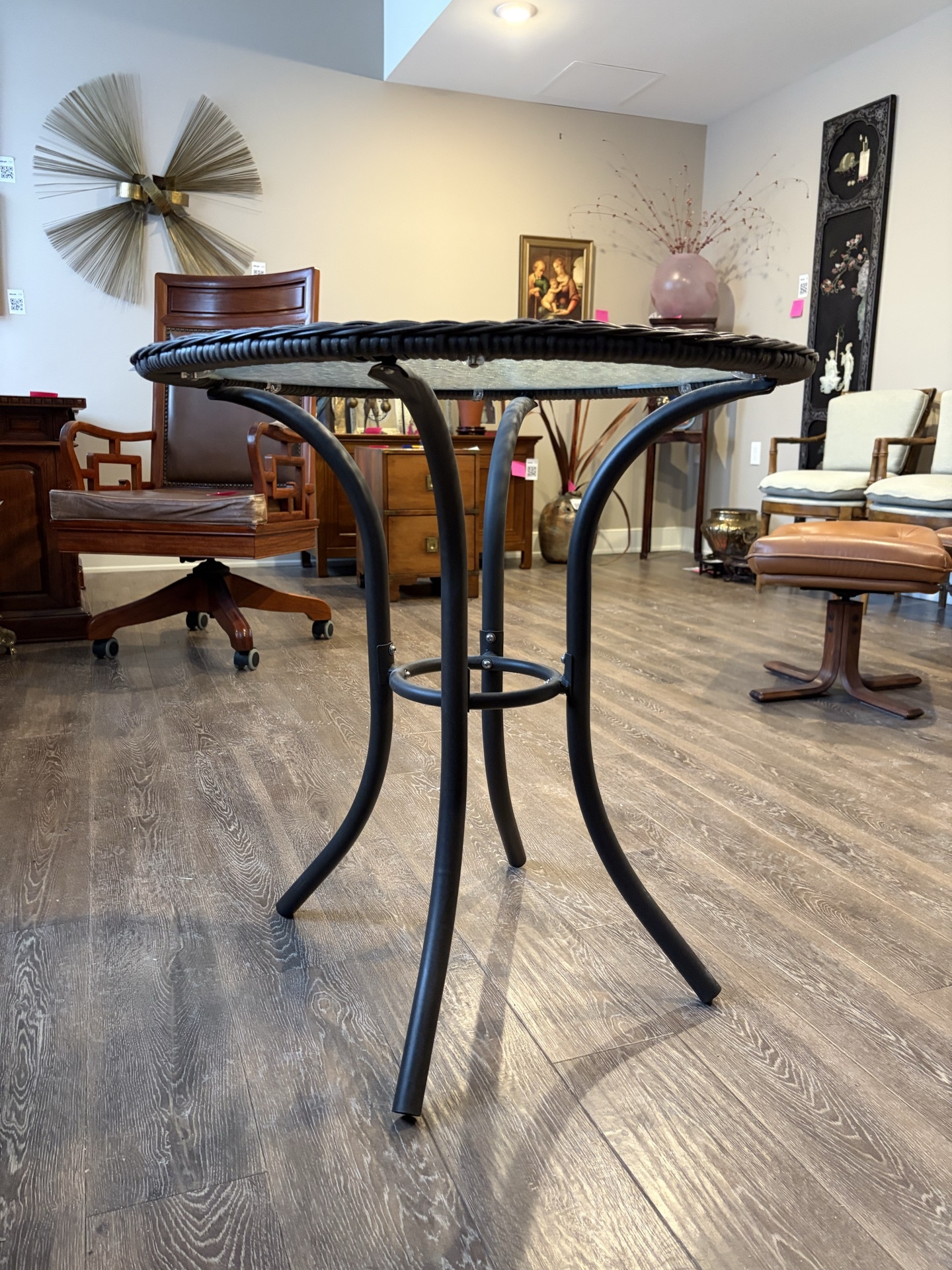 Round wicker-edge glass-top table with curved metal legs - image 1 of 4