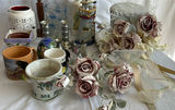 Assorted decorative home items: mugs, vases, candle holders, and frosted artificial roses - thumbnail 1 of 6
