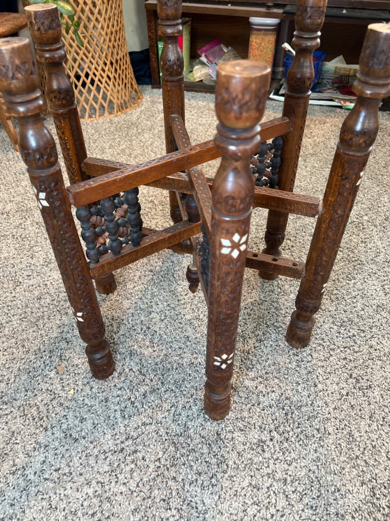 Round brass engraved tray/table with carved wooden chair frame, and red patterned rug - image 4 of 11
