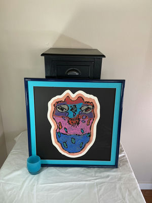 Black end table with drawer and framed abstract artwork, plus blue glass candle holder - Image 1 of 7