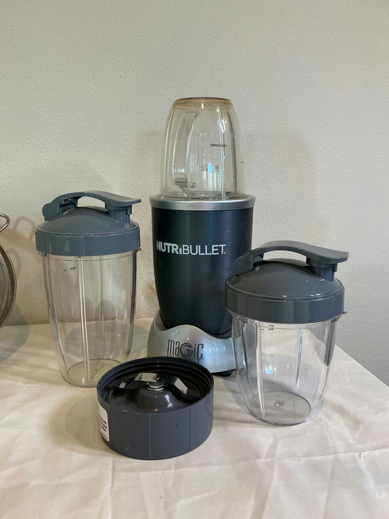 NutriBullet blender with cups and lids, mesh strainers, measuring beaker, and kitchen scale - image 2 of 3