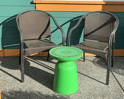 Two brown woven outdoor chairs with a green round metal side table - Image 1 of 4