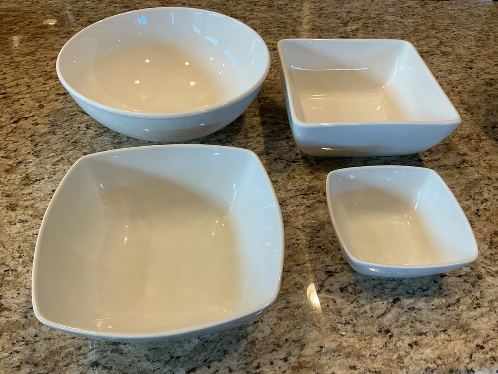 Four white ceramic serving bowls in varying sizes. - image 1 of 4