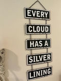 Five-panel hanging sign reading 'EVERY CLOUD HAS A SILVER LINING' and a decorative metal wall sconce with candle - thumbnail 3 of 4