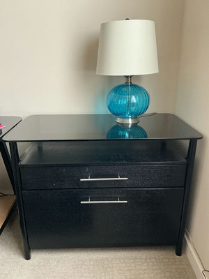 Black two-drawer file cabinet with glass top and blue glass lamp - Image 1 of 4