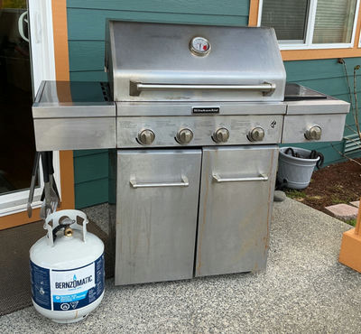 KitchenAid propane grill with extra tank and cover.  - Image 1 of 6