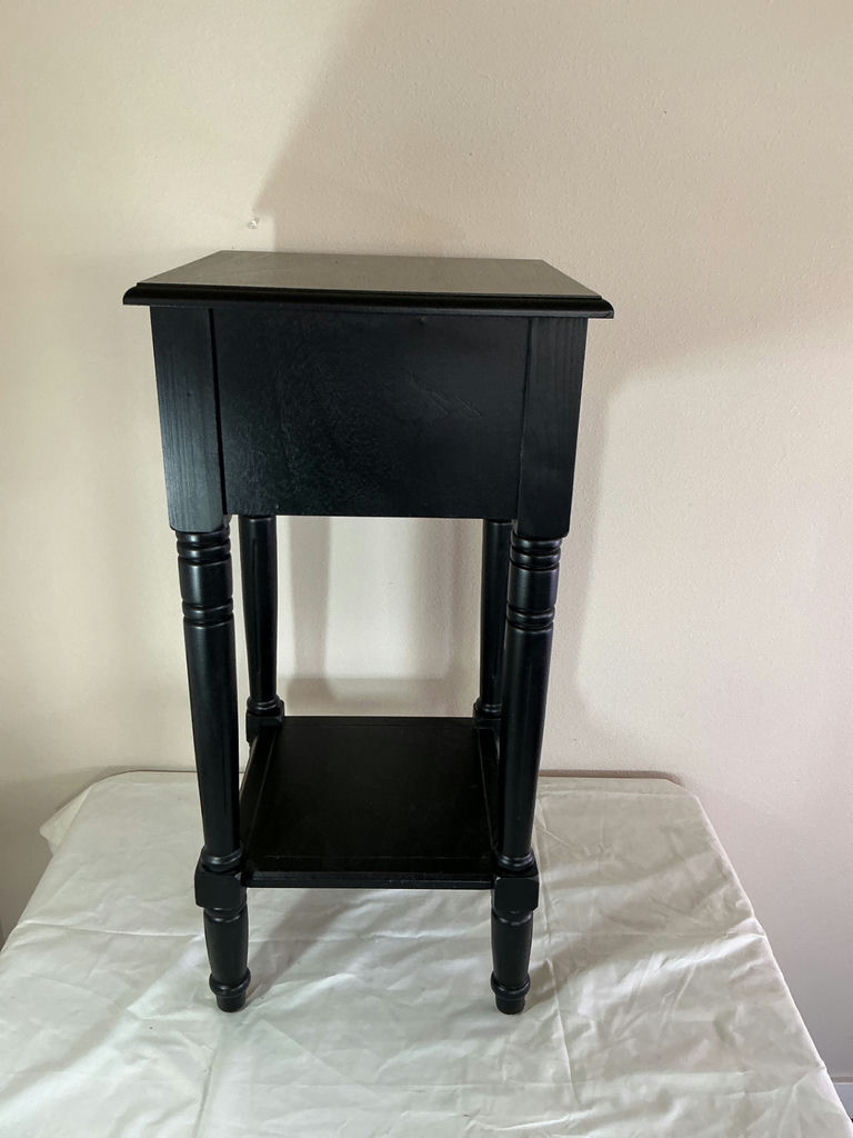 Black end table with drawer and framed abstract artwork, plus blue glass candle holder - image 3 of 7