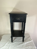 Black end table with drawer and framed abstract artwork, plus blue glass candle holder - thumbnail 2 of 7