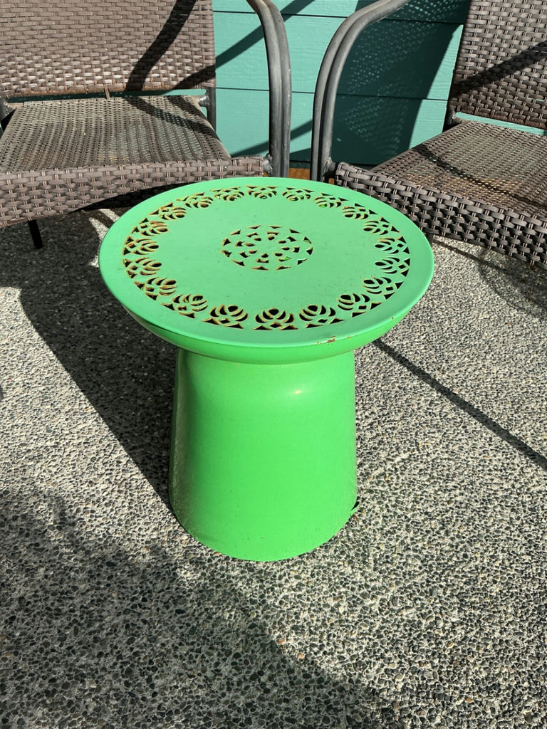 Two brown woven outdoor chairs with a green round metal side table - image 2 of 4