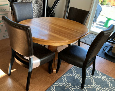Round wooden dining table with pedestal base and four upholstered chairs - Image 1 of 5