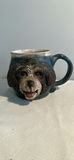 Ceramic art collection: blue-green face sculpture, monkey-mug, and abstract forms - thumbnail 7 of 8