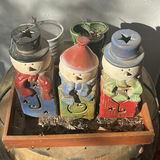 Decorative Ceramic Snowman Containers, Metal Garden Stool, and Artificial Poinsettia Arrangements - thumbnail 2 of 5