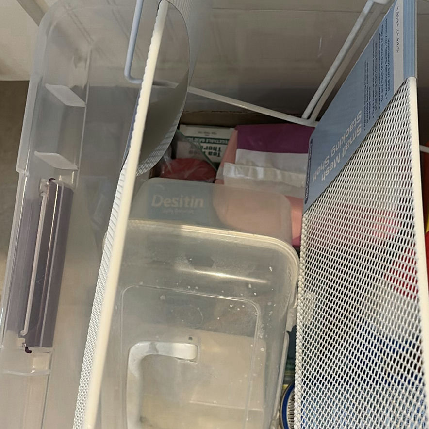 Clear plastic storage tote with cleaning supplies and miscellaneous items - image 4 of 4