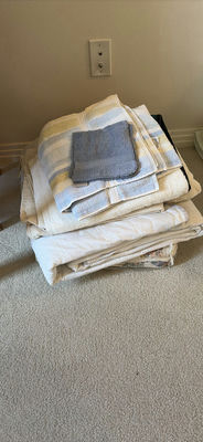 Stack of bedding items: towels, blankets, and a quilt - Image 1 of 6