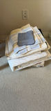 Stack of bedding items: towels, blankets, and a quilt - thumbnail 1 of 6