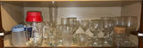 Assorted glassware and mugs on cabinet shelf - thumbnail 1 of 5