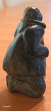 Inuit Soapstone Carving – Kneeling Figure in Traditional Parka Hand-carved stone sculpture depicting a kneeling Inuit figure wearing a traditional hooded parka, with detailed facial features and a naturalistic, weighted posture. - thumbnail 2 of 3