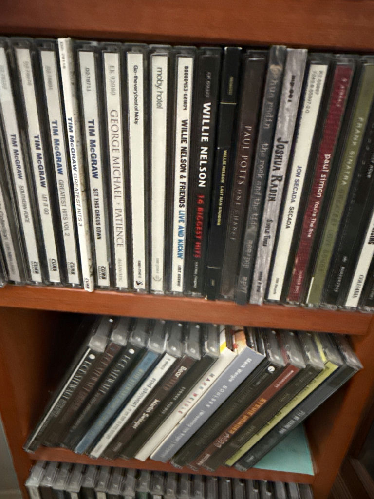 CD collection on wooden shelf - image 4 of 5
