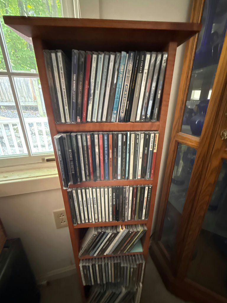 CD collection on wooden shelf - image 1 of 5