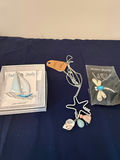 Assorted fashion jewelry: sailboat pendant, dragonfly brooch, and shell charms - thumbnail 1 of 4