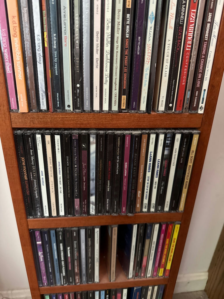 Tall wooden CD storage tower with stacked CD cases - image 5 of 5