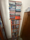 Tall wooden CD storage tower with stacked CD cases - thumbnail 2 of 5