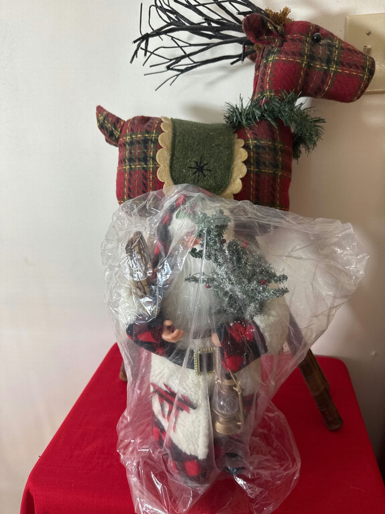 Plaid Santa figure in front of plaid reindeer sculpture - image 1 of 3