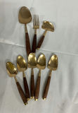 Gold-tone flatware set with white and pink handles and wooden-handled utensils - thumbnail 3 of 10