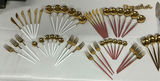 Gold-tone flatware set with white and pink handles and wooden-handled utensils - thumbnail 1 of 10
