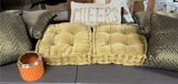 Beige tufted cushions with chevron pillows and orange candle holder - thumbnail 1 of 4