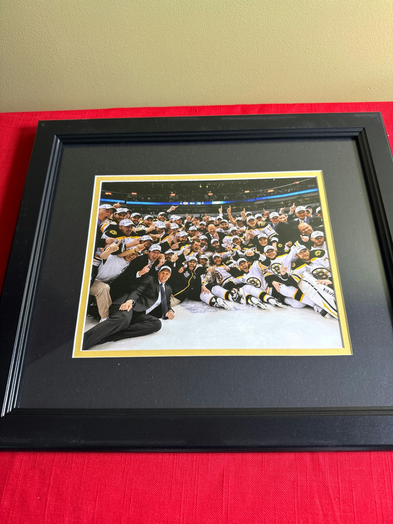 Framed group photo of a Bruins  team celebration - image 1 of 3