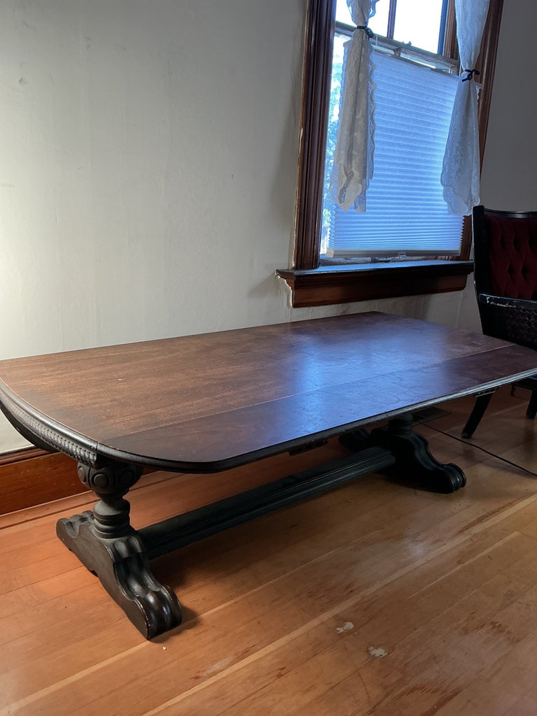 Dark wooden coffee table with ornate carved pedestal bases - image 5 of 7