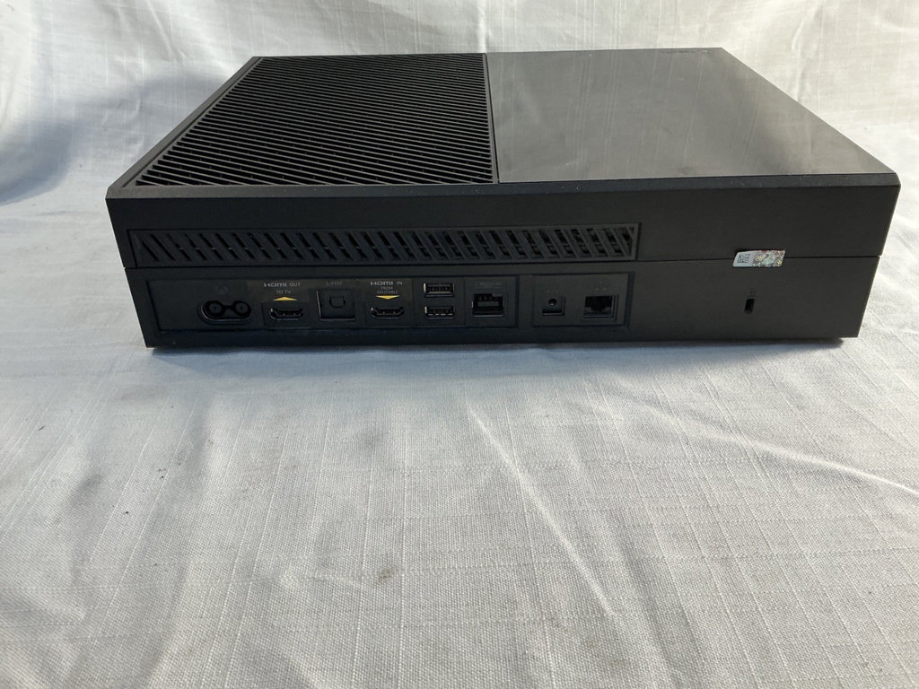 Xbox One X console with three controllers and a game - image 4 of 8