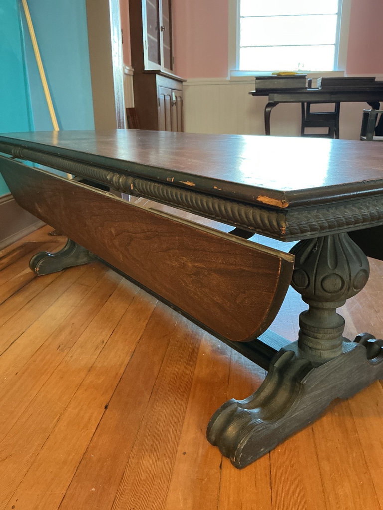 Dark wooden coffee table with ornate carved pedestal bases - image 1 of 7