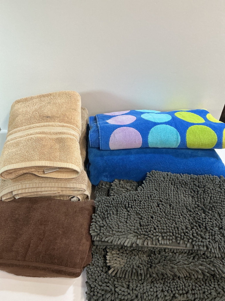 Assorted towels, bath mats and a blanket. - image 1 of 4