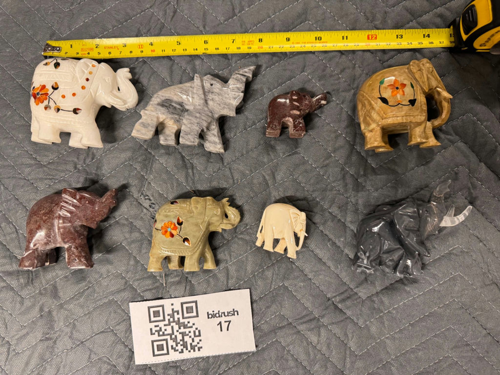 Collection of hand-carved elephant figurines in multiple colors - image 1 of 13