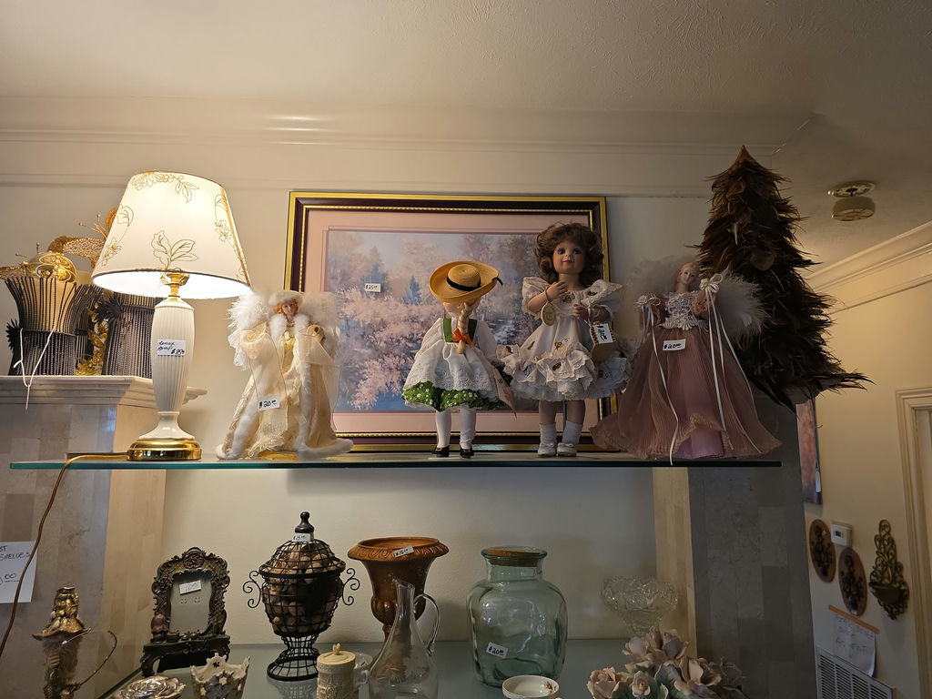 Vintage glassware and porcelain figurine collection on glass shelves - image 2 of 5