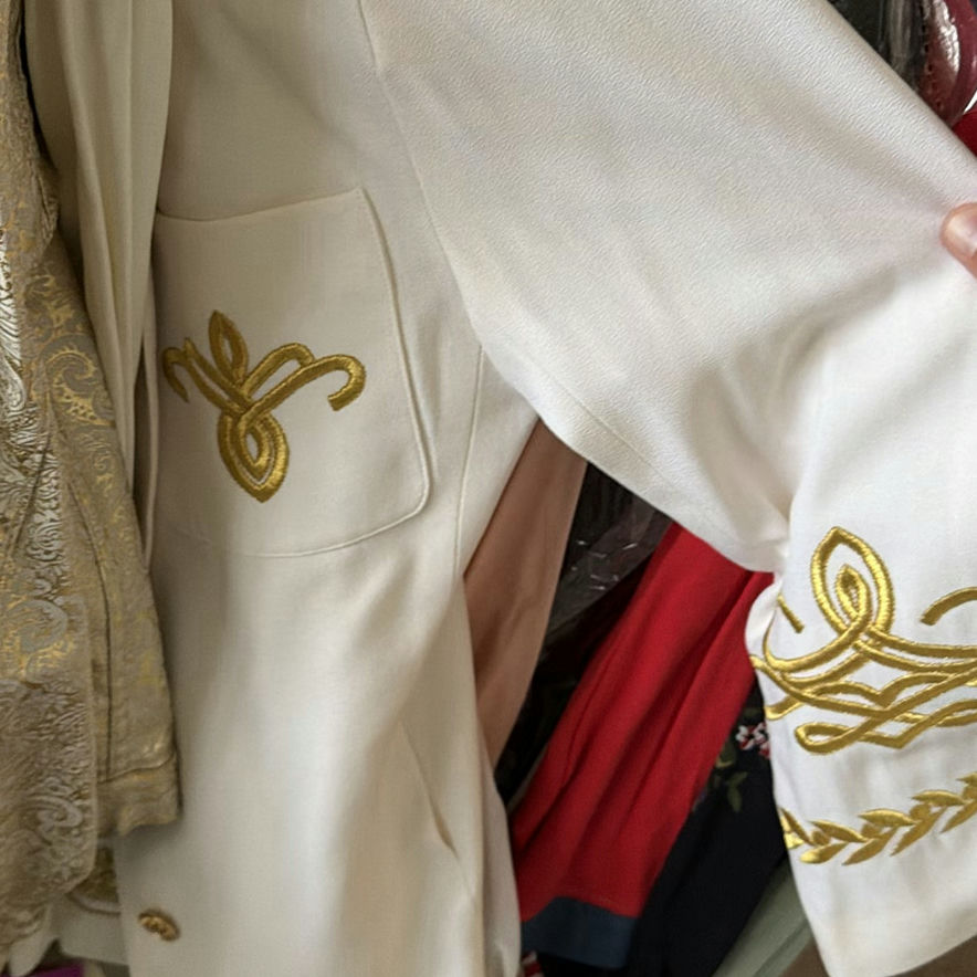 Assorted women's dresses and jackets on a garment rack - image 5 of 8