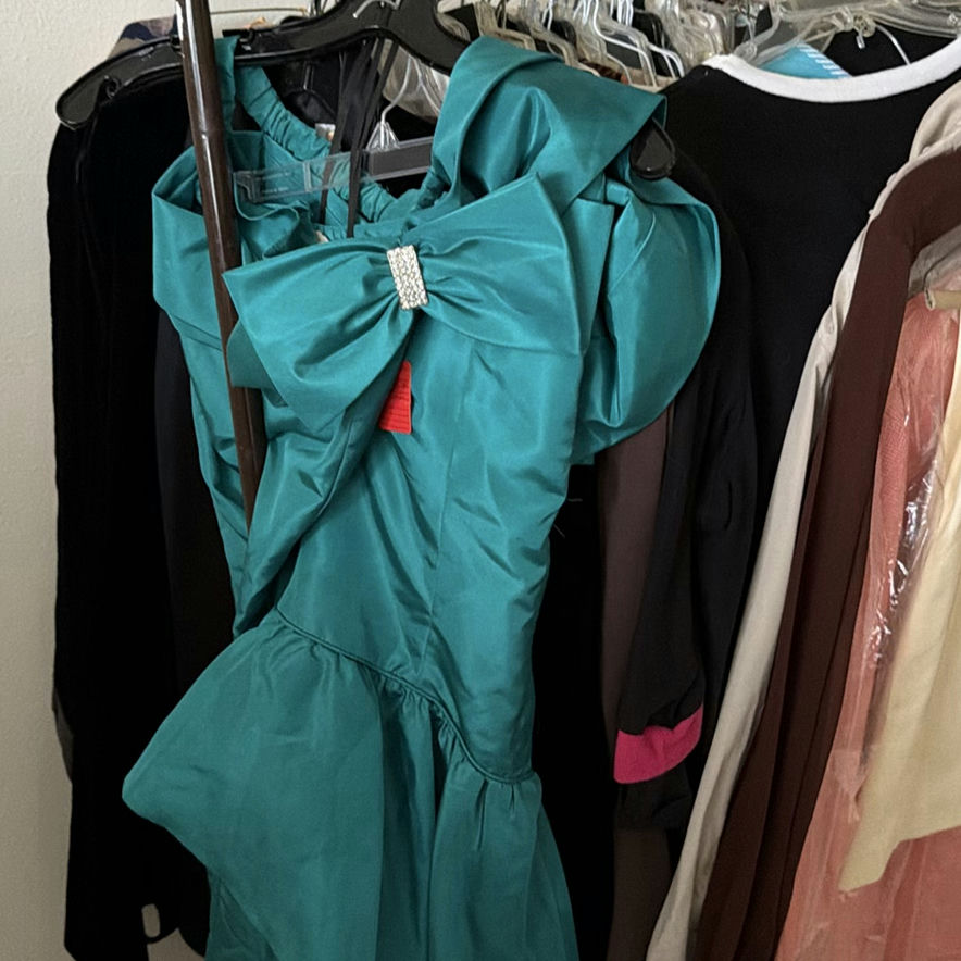 Assorted women's dresses and jackets on a garment rack - image 2 of 8