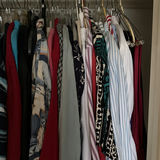 Assorted shirts and blouses on closet hangers - thumbnail 2 of 5